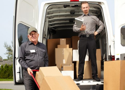 Man and van moving boxes in Harrow residential street
