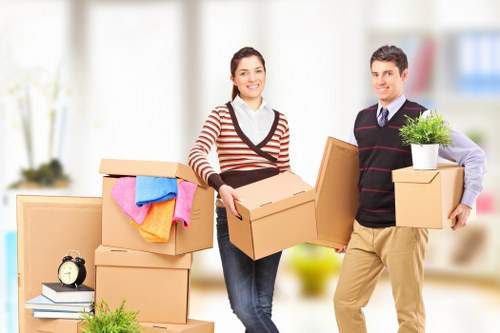 Trained movers handling household items with protective gloves